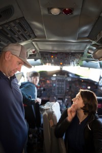 Instructor Dan Madden shows student Teresa Olguin how to start the APU system of the Boeing 727 at McClellan Park Airfield.